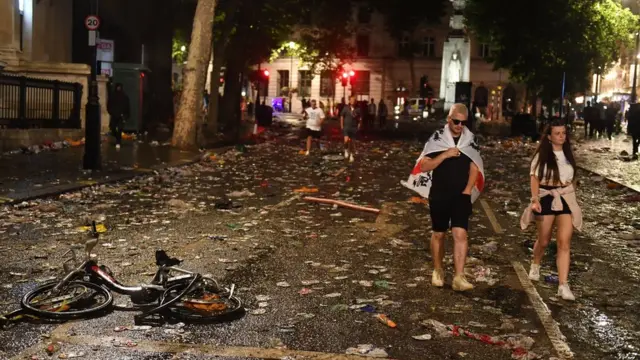 Dejected fans leave the central London fan zone
