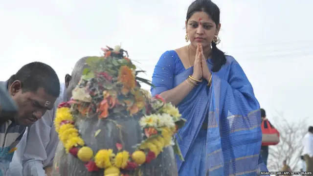 Hindu devotees offer prayers to a Shiva Lingam, a stone sculpture representing the phallus of the Hindu God Lord Shiva, during Maha Shivaratri at the Keesara Gutta temple on the outskirts of Hyderabad on February 13, 2018.