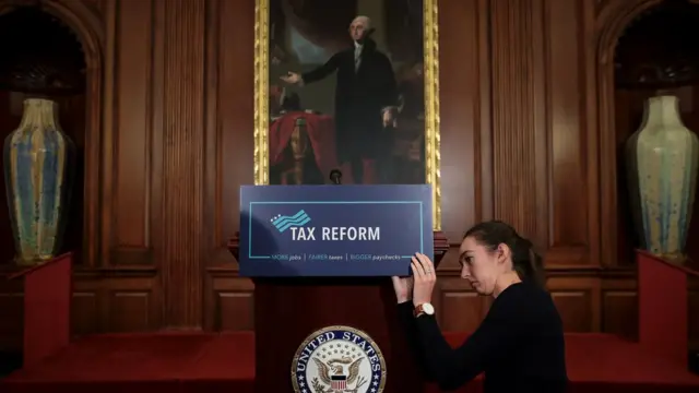 అమెరికా కాంగ్రెస్ భవనంలోని ఒక హాలులో పన్ను సంస్కరణల ప్రణాళిక వేదికను అమరుస్తున్న సహాయకురాలు