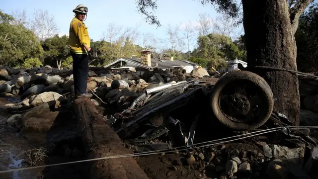 Rescue worker surveys debris after deadly mudslide in California. 10 Jan 2018
