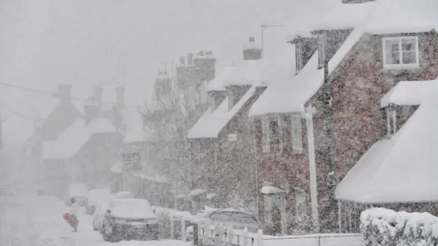 Snow cover houses , road and cars for Brenchley southeast England