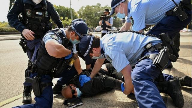 A protester is arrested by police in Sydney, Australia, 21 August 2021