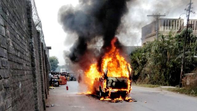 A burning vehicle in a street