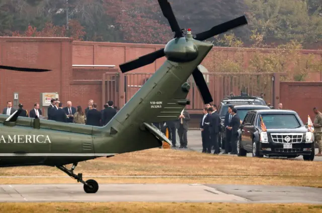 White House senior staff discuss the situation as U.S. President Donald Trump sits in his car after being grounded from an attempt to visit the Demilitarized Zone (DMZ) in the truce village of Panmunjom dividing North Korea and South Korea, at a U.S. military post in Seoul, South Korea, November 8, 2017. REUTERS/Jonathan Ernst