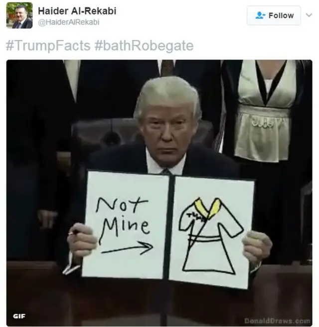 A moving image of President Trump holding up a drawing of a bathrobe with the words 'not mine'