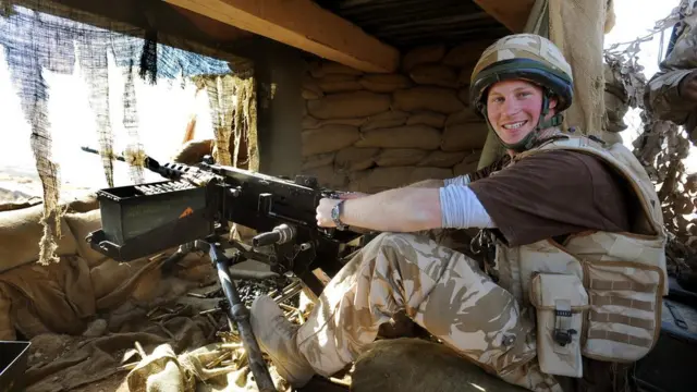 Prince Harry with a machine gun