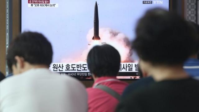 People in Seoul, South Korea, watch breaking news of North Korea's missile launch in July 2019