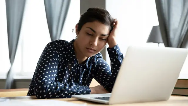 A woman asleep at her desk