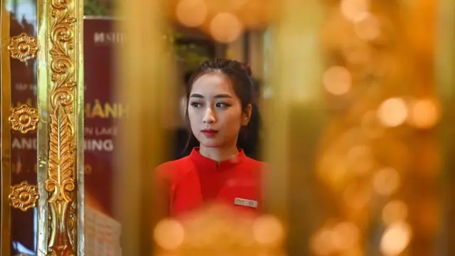 A staff member waits to welcome guests in the lobby of the newly-inaugurated Dolce Hanoi Golden Lake hotel
