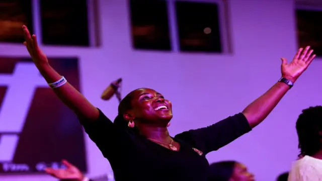 A worshipper expresses joy during church service at Living Faith Church in Abuja, Nigeria - Sunday 22 March 2020
