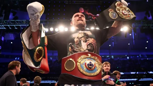 Oleksandr Usyk holds his belts