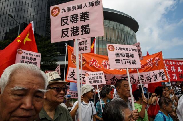 Pro-Beijing supporters gather outside the Legislative Council in Hong Kong on October 26, 2016.