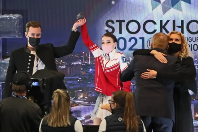 Figure skater Anna Shcherbakova (C) of Russia, the gold winner, celebrates her victory with her coaches Daniil Gleikhengauz (L), Eteri Tutberidze (R), and Sergei Dudakov (2nd R)