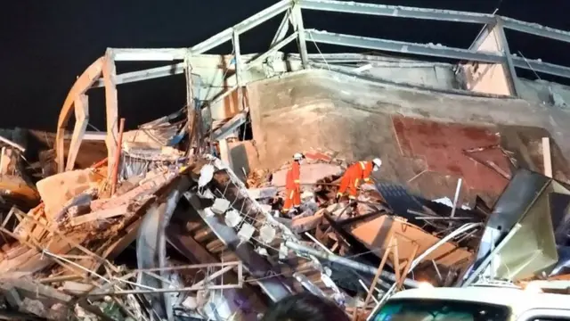 Rescue workers are seen on the site where a hotel being used for the novel coronavirus quarantine collapsed in the southeast Chinese port city of Quanzhou, Fujian province, China March 7, 2020