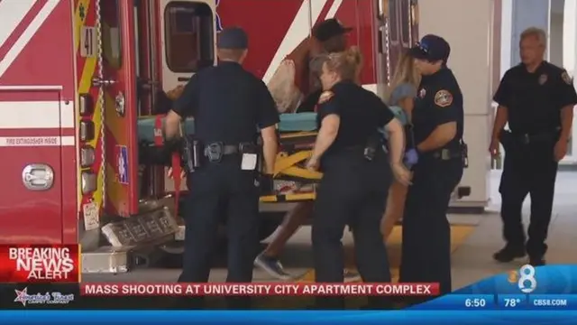 police loading injured person onto ambulance