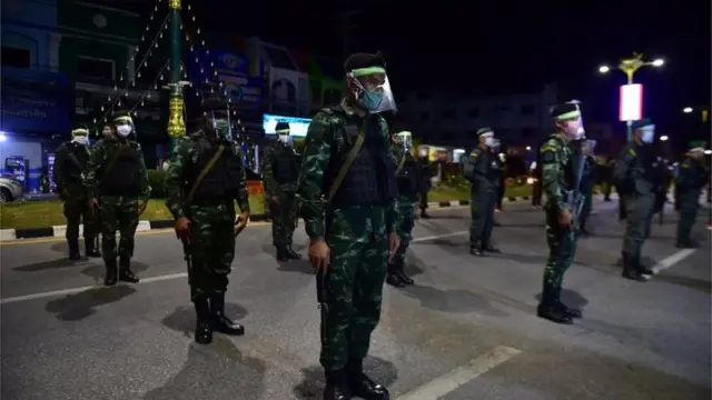 This photo taken on April 3, 2020 shows soldiers wearing protective gear on an empty road in Thailand"s southern province of Narathiwat, before a night of enforcing a nationwide night curfew aimed at stemming the spread of the COVID-19 coronavirus