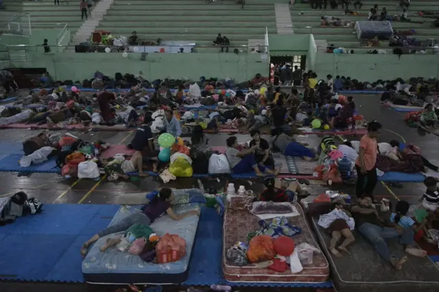 Villagers rests at a temporary evacuation centre, for people living near Mount Agung, a volcano on the highest alert level, inside a sports arena in Klungkung, on the resort island of Bali, Indonesia, 24 September 2017 in this photo taken by Antara Foto.