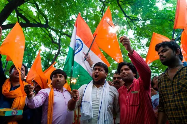 Members of Hindu Sena, a rightwing group, celebrate after the abolition of Article 370 in Delhi