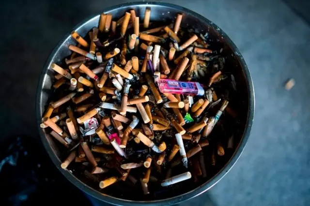 An ashtray with cigarette butts is pictured at a railway station in Shanghai.
