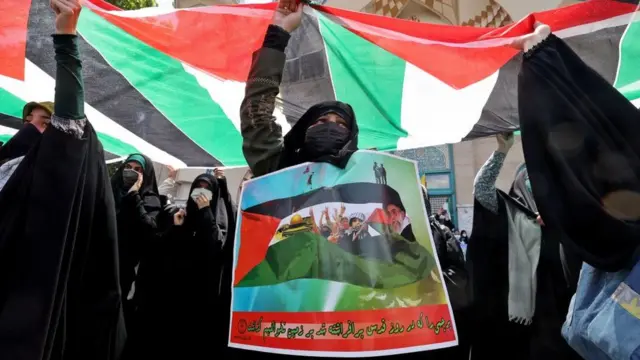 Fully-veiled Iranian protesters wave Palestinian national flags during a protest to condemn the ongoing Israeli air campaign on Gaza at Palestine Square in central Tehran, on May 18, 2021. - The UN Security Council was to hold an emergency meeting amid a diplomatic push to end the devastating conflict between Israel and Gaza's armed groups that has killed more than 220 people, most of them Palestinians. (Photo by ATTA KENARE / AFP) (Photo by ATTA KENARE/AFP via Getty Images)