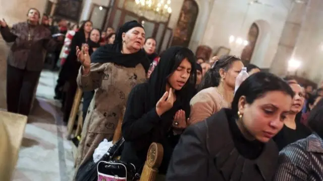Coptic Orthodox Christian pray during a religious session by father Makary at St Mark Cathedral in Cairo December 26, 2014