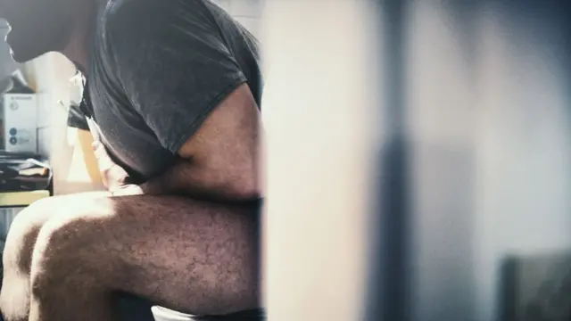 Man sitting at the toilet