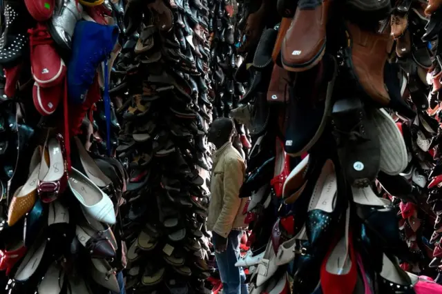 A customer looks at shoes made in China on display at a store in the central business district of Nairobi on January 10, 2018.