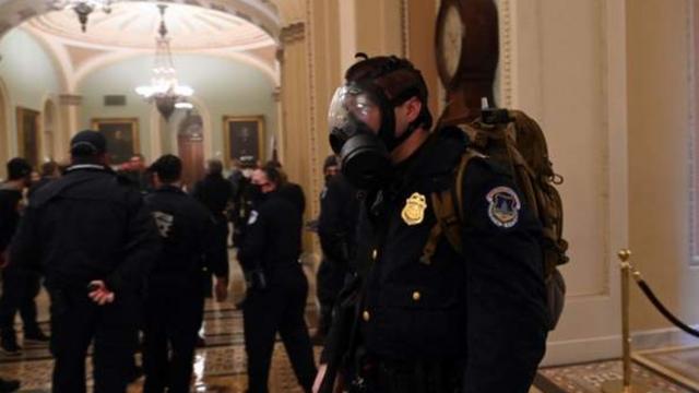 議事堂内でガスマスクを着けた警官