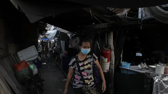 A woman with shopping walks along an alleyway