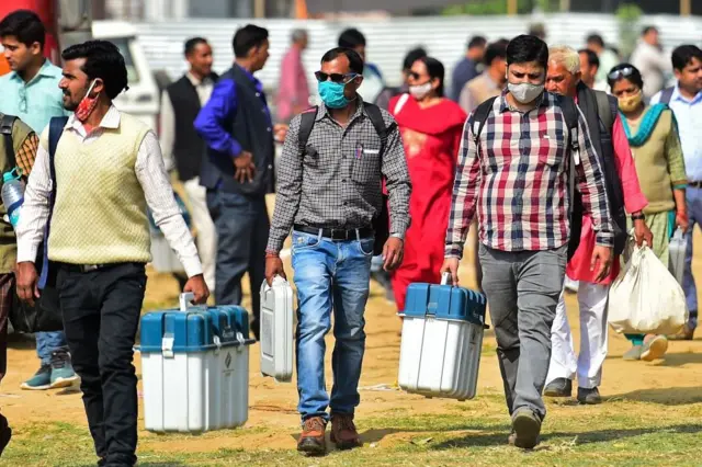 ઈવીએમ અને વીવીપેટ લઈને જઈ રહેલા કર્મચારીઓ