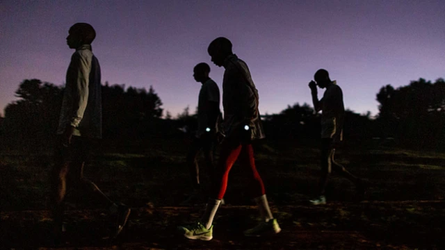 Kipchoge and other runners gather in the early morning half-light