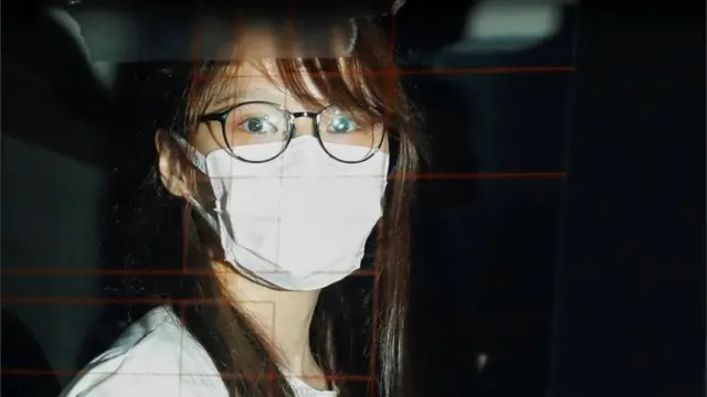 Agnes Chow in a police car in Hong Kong