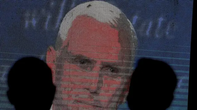 People watch the debate between U.S. Vice President Mike Pence and Democratic vice-presidential nominee Kamala Harris outside a tavern in San Diego, California, U.S., October 7, 2020