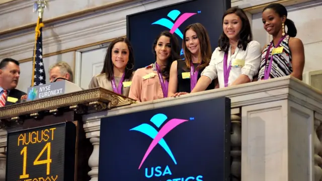 US Women's Gymnastics Olympic Gold Medal team, (L-R), Jordan Wieber, Aly Raisman, McKayla Maroney, Kyla Ross and Gabby Douglas wait to ring the closing bell at the New York Stock Exchange in 2012.