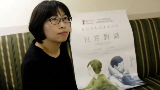 This picture taken on March 9, 2017 shows Huang Hui-chen, director of 'Small Talk', displaying the film's poster during an interview at a cafe in Taipei.