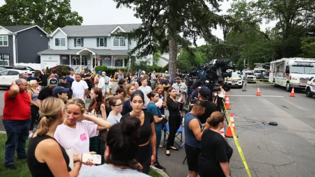 Neighbours gather as authorities search Mr Heuermann's house