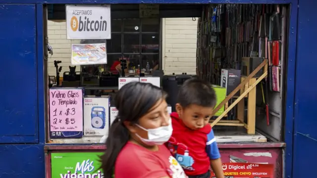 Mujer con hijo caminando por El Zonte, El Salvador
