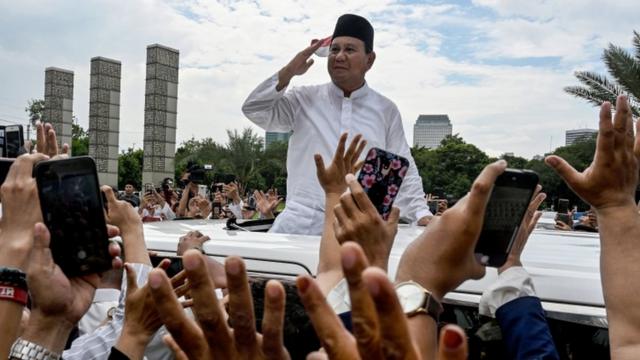 Indonesia's presidential candidate Prabowo Subianto gestures to supporters as he leaves a mosque after Friday prayers in Jakarta on 19 April, 2019