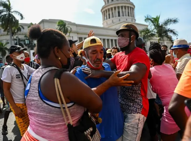 A protester being arrested by plain-clothes police in Havana
