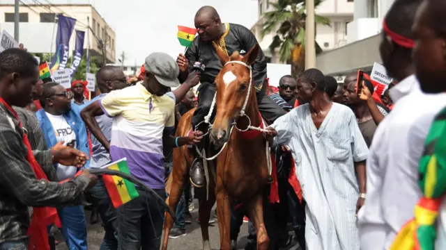 Hassan Ayariga (C), the founder of the All People"s Congress (APC) party, rides on horseback during a protest against the expansion of Ghana's defence cooperation with the United States, in the streets of Accra, Ghana 28 March 2018.