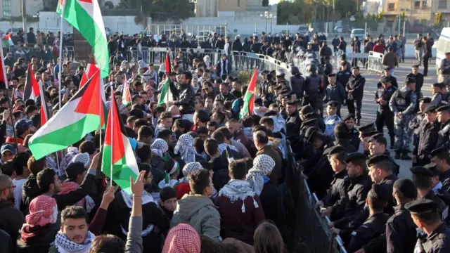 Protesters shout slogans and wave Palestinian flags during a demonstration against the US president's decision to recognise Jerusalem as the capital of Israel, near the American embassy in Amman, on December 8, 2017.