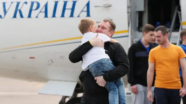 Freed Ukrainian prisoner embraces his relative upon arrival in Kiev after Russia-Ukraine prisoner swap, at Borispil International Airport, outside Kiev.