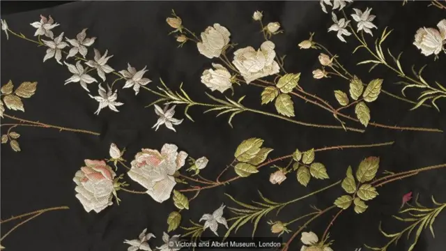 这是19世纪末制作的一条丝绸料子的细节图，上面精美地绣着玫瑰花纹。(Credit: Victoria and Albert Museum, London)
