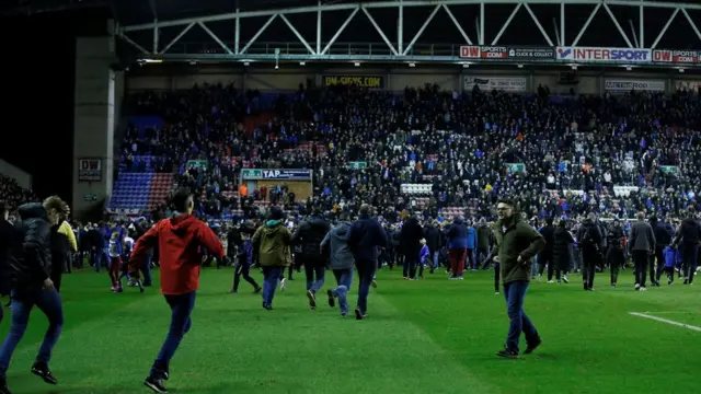 مشجعو ويغان يحتفلون مع اللاعبين بعد المباراة