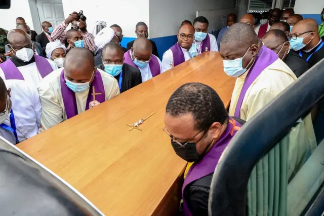 Pallbearers carry the coffin of Cardinal Christian Tumi to a hearse after mass in Douala, Cameroon.