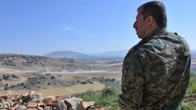 YPG döyüşçüsü Afrin ətrafında əraziyə baxış keçirdiyi zaman -9 iyun, 2017