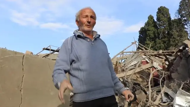 Пожилой человек на руинах