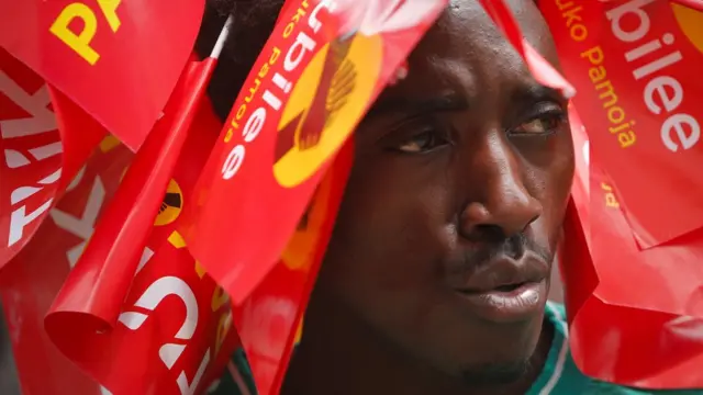 A supporter of President Uhuru Kenyatta wears campaign flags on his head in Nairobi, 23 October