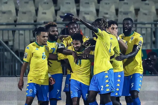 Gabon forward Jim Allevinah celebrates wit im teammates afta e score di equalising goal against Ghana