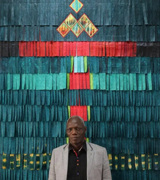 Man standing by work of art